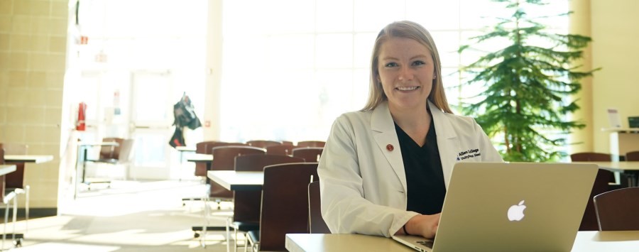 Doctor of Health Profession Education student with computer 