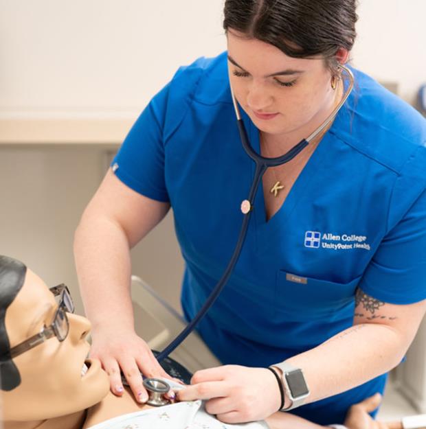 Photo of a nursing student in the sim lab